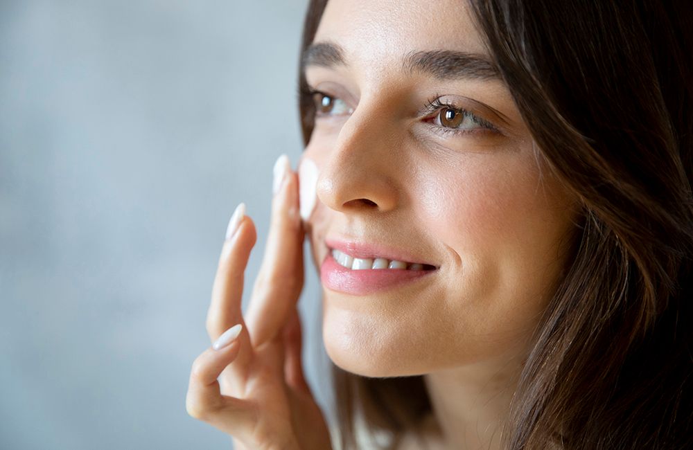 woman applying face cream