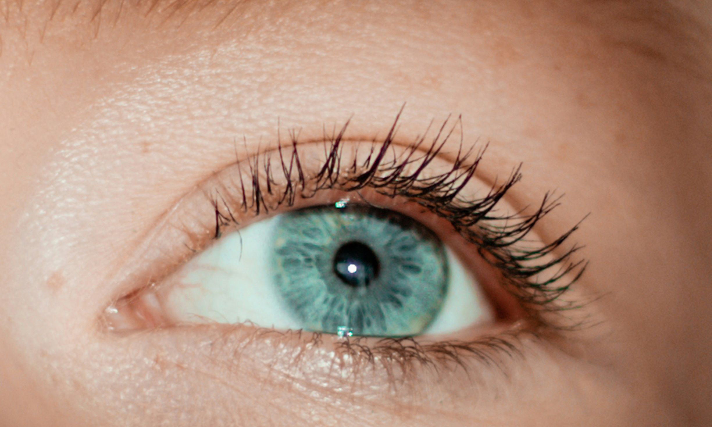 close up of woman with greenish blue eye