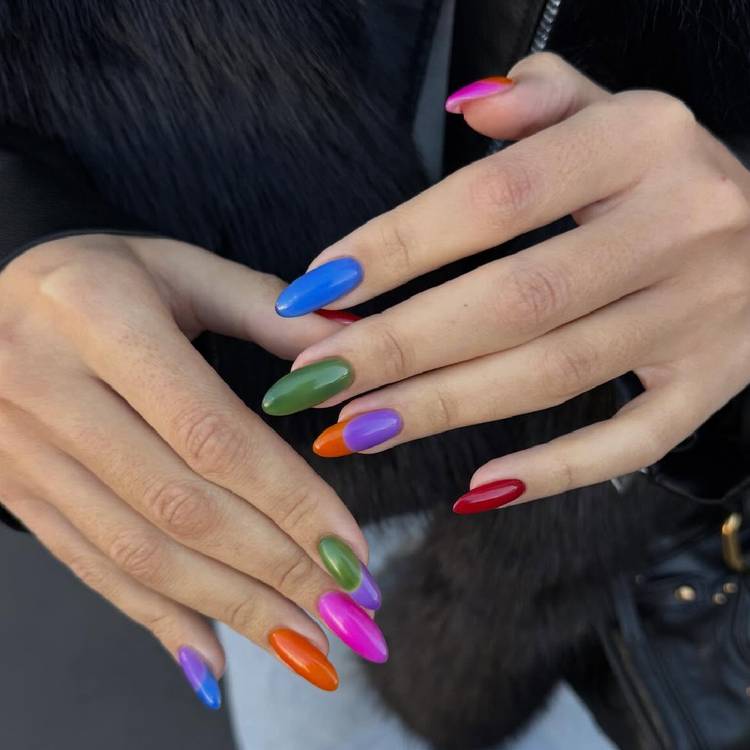 Hands with glossy, pill box–inspired nails in bright blue, green, orange, pink, purple and red shades.