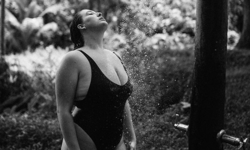 woman with curvy body in a bathing suit in an outdoor shadow