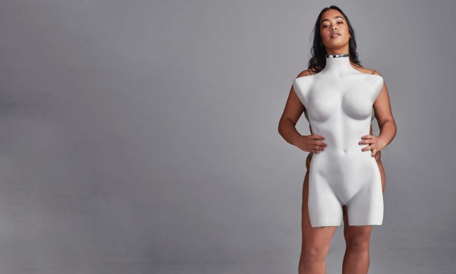 woman holding mannequin body against gray body