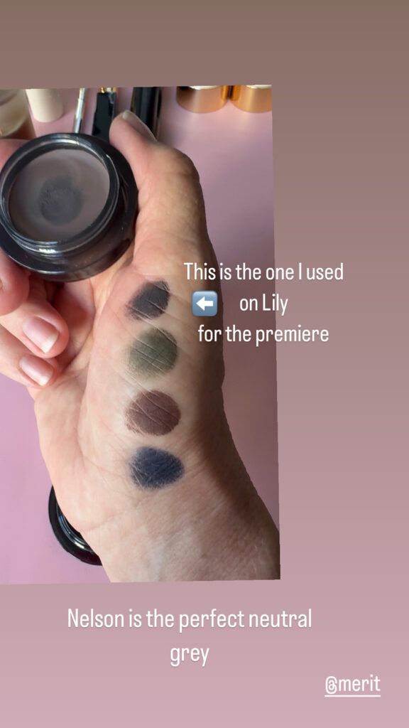 hand holding merit beauty solo shadow with color swatches on hand