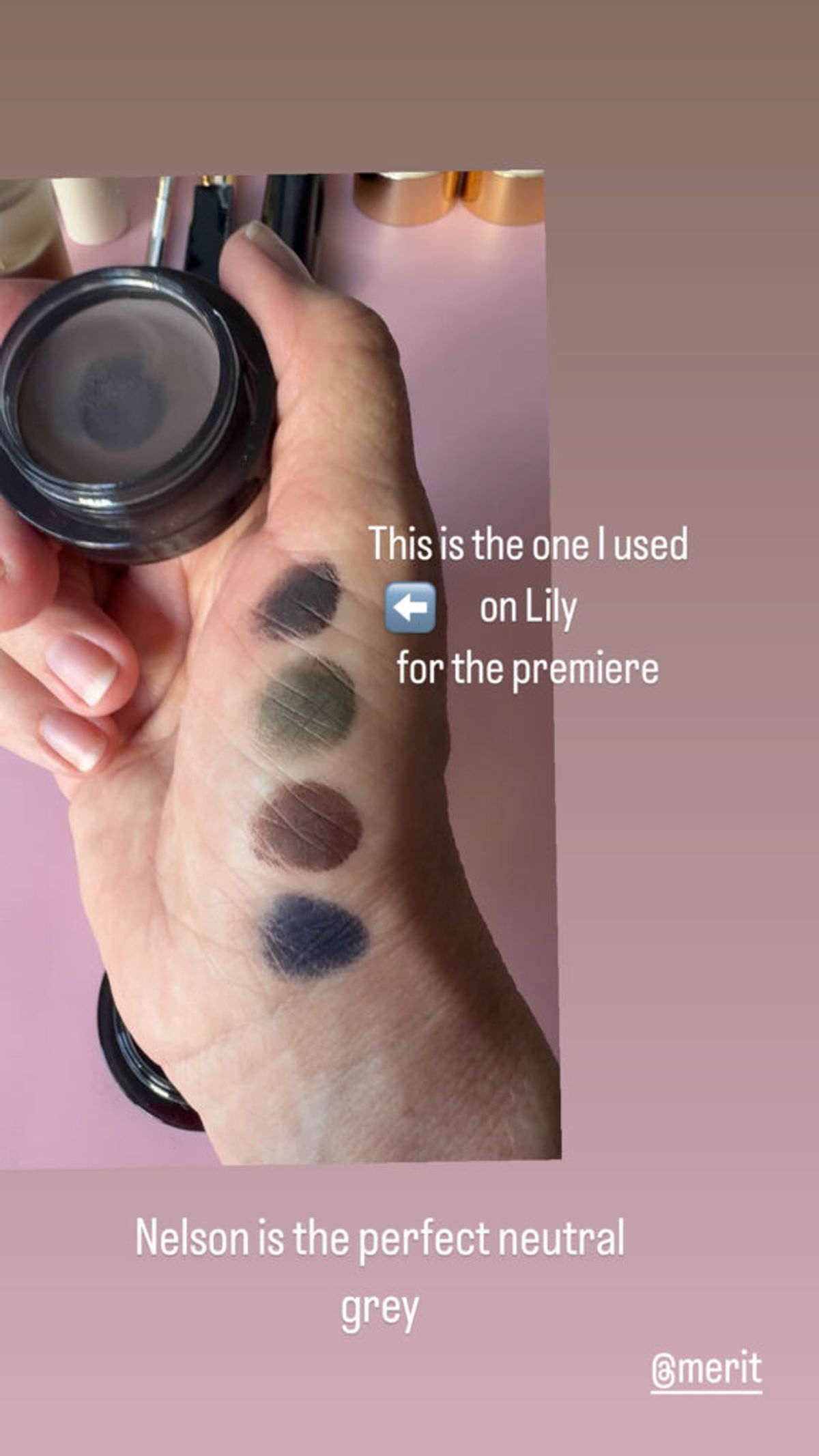 hand holding merit beauty solo shadow with color swatches on hand