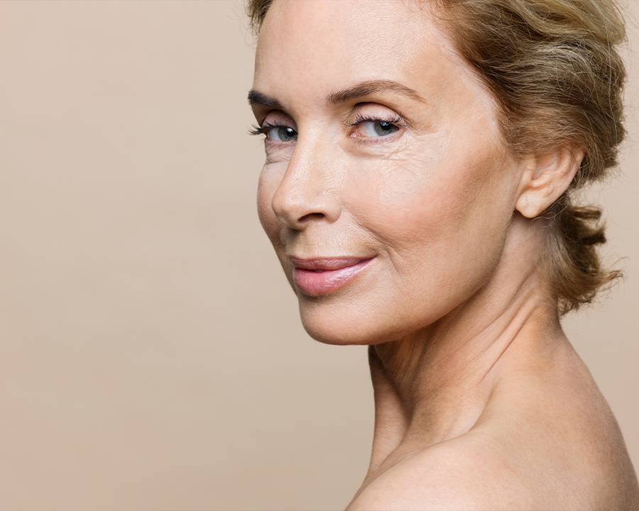 older woman on beige background