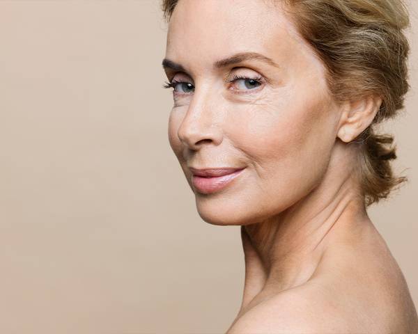 older woman on beige background