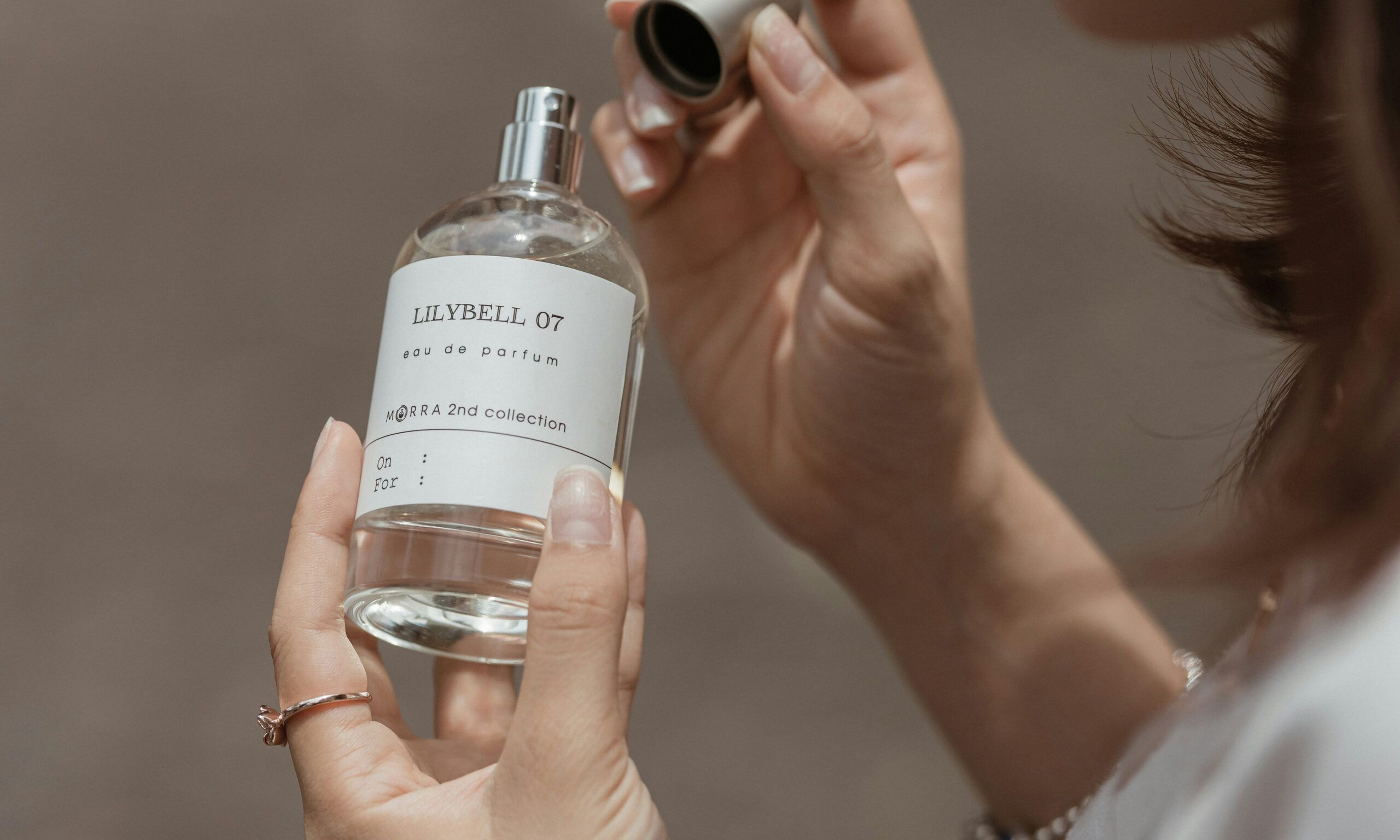 woman opening perfume bottle