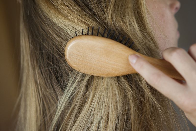 woman brushing blonde hair