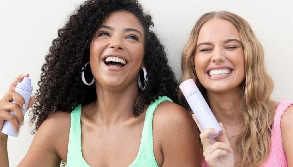 Women holding SPF setting spray