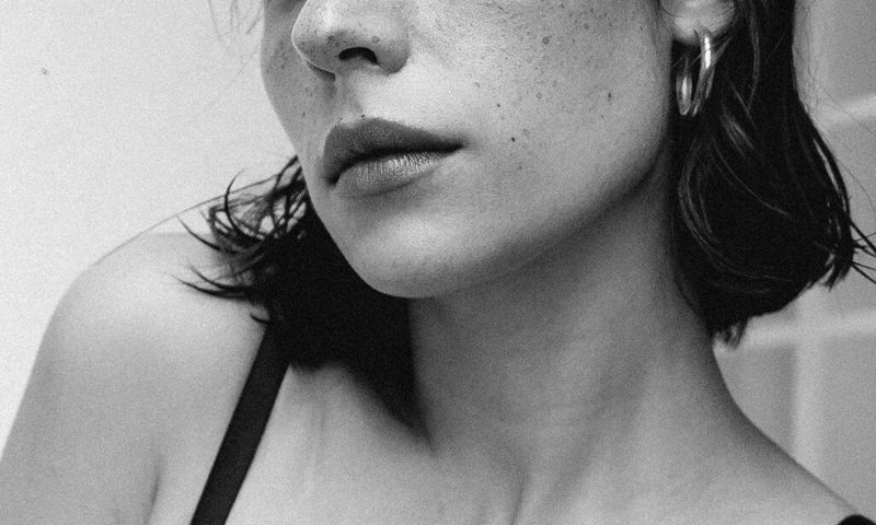 zoomed in black and white photo of woman's lower face and jawline
