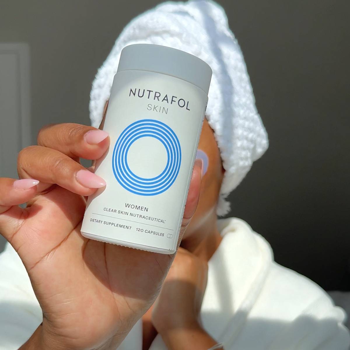 woman holding nutrafol skin neutraceutical