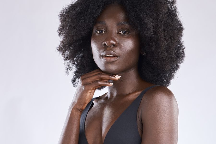 Shot of a young woman posing in her underwear against a studio background