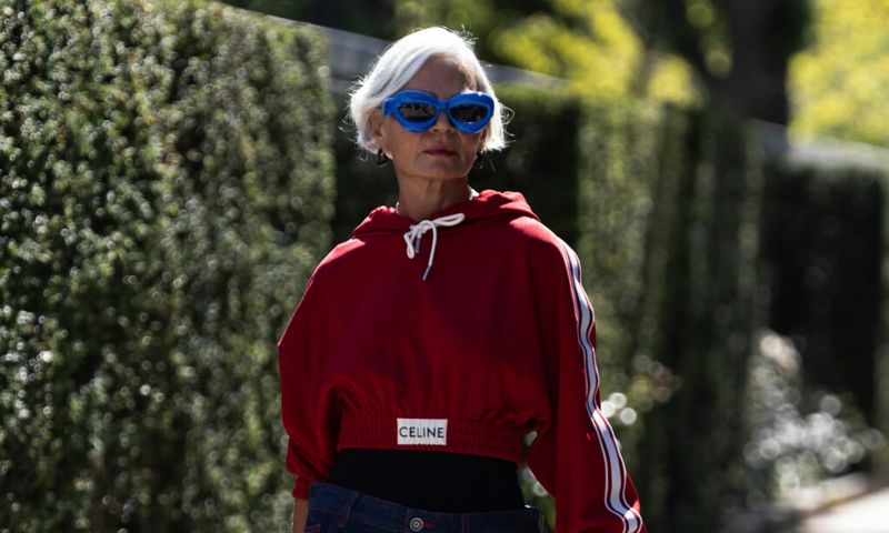 mature woman walking outdoors in sunglasses