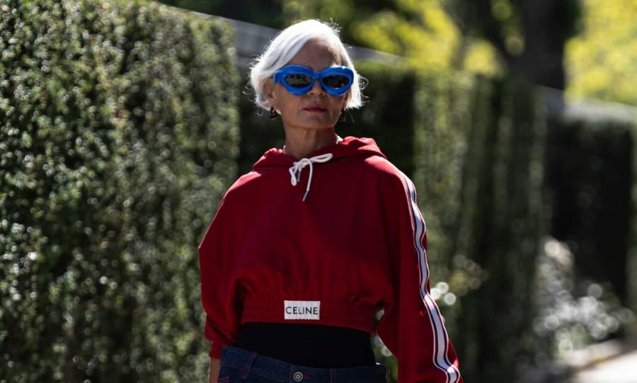 mature woman walking outdoors in sunglasses