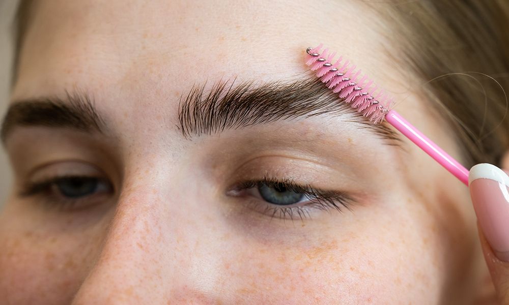 The Master Combs The Eyebrows Of The Client After Lamination Of The Eyebrows.