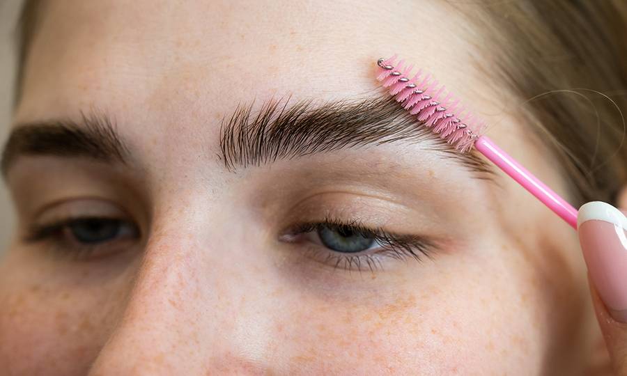 The Master Combs The Eyebrows Of The Client After Lamination Of The Eyebrows.