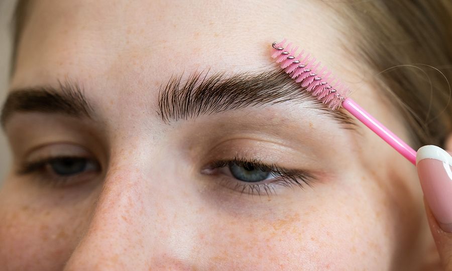 The Master Combs The Eyebrows Of The Client After Lamination Of The Eyebrows.