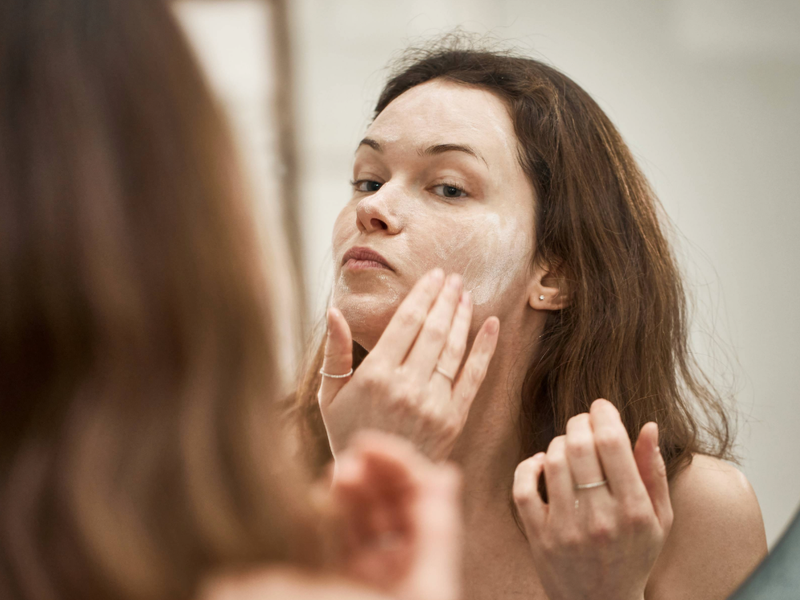 woman washing her face