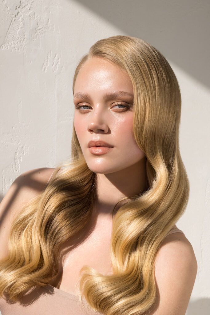 Close up studio shot of a beautiful natural blonde woman with freckles skin.