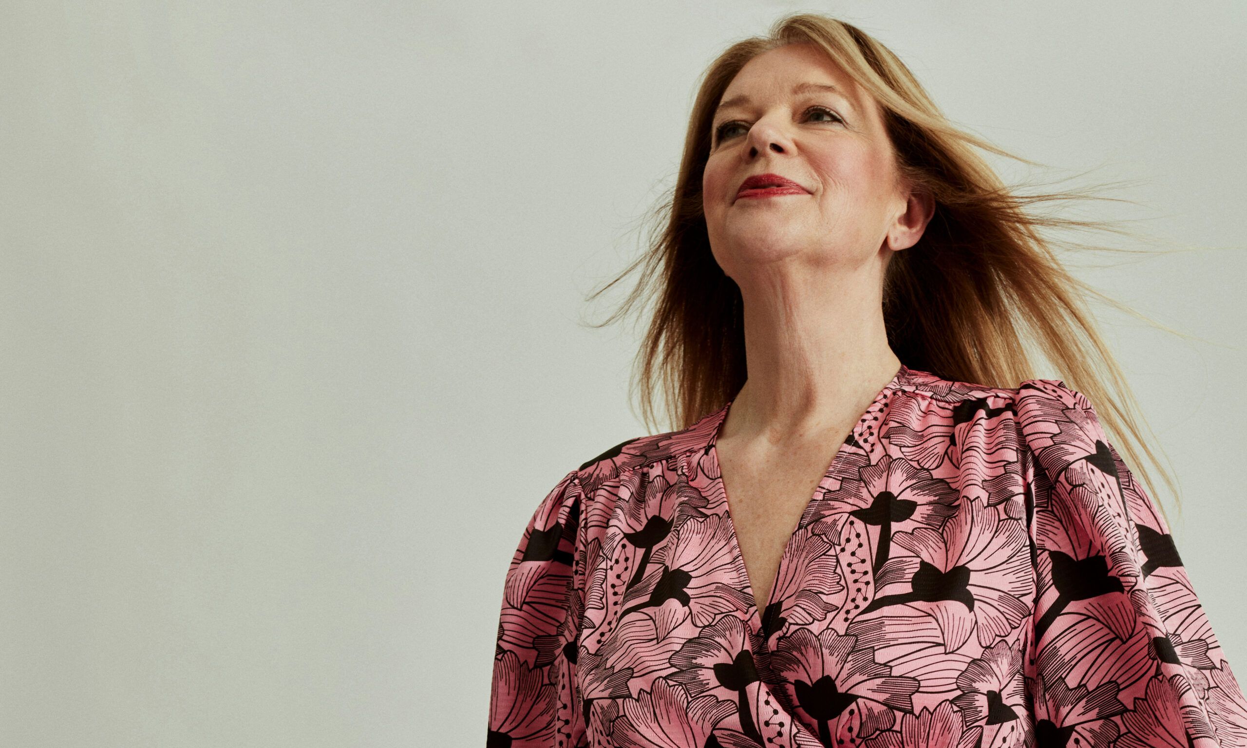 older woman in pink and black dress