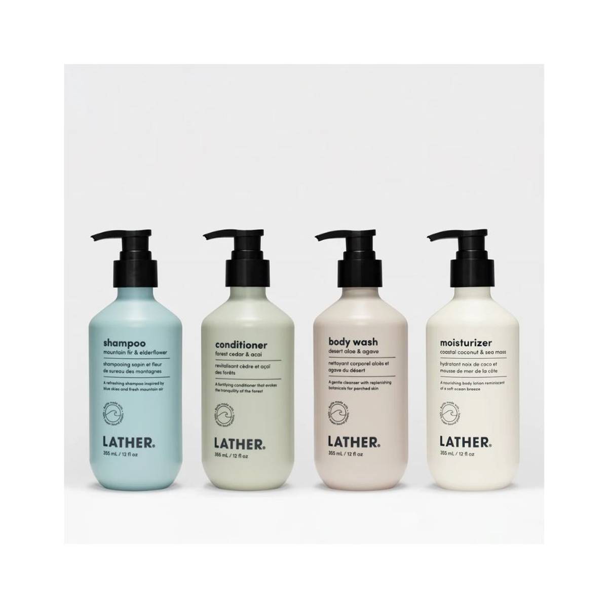 Four different colored containers of shampoo, conditioner, body wash, moisturizer