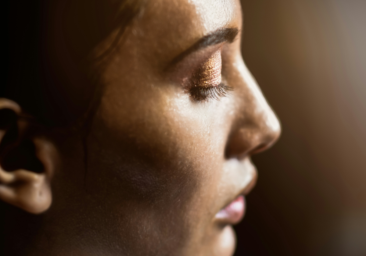 Side profile close-up showing smooth, radiant skin with visible natural texture