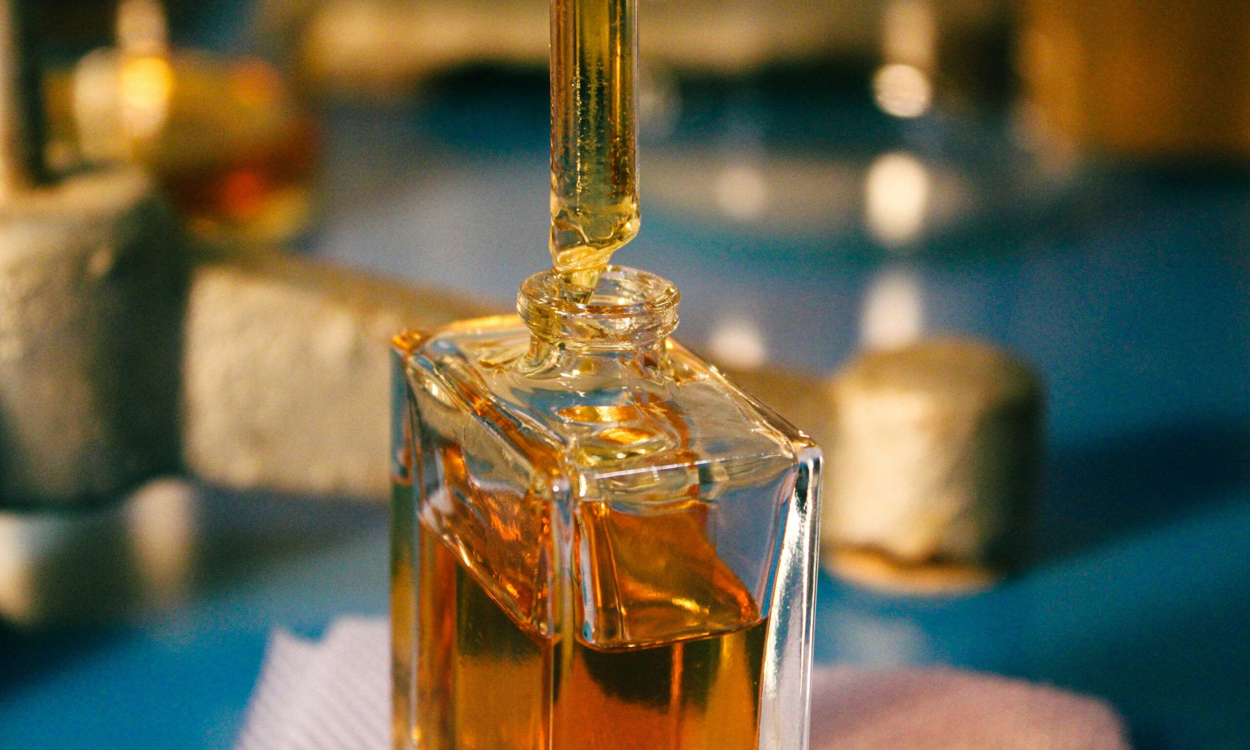 a bottle of liquid with dropper sitting on top of a table