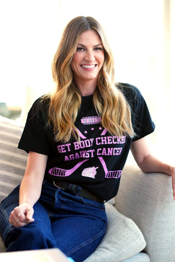 Erin Andrews wearing "Get Body Checked Against Cancer" T-shirt.