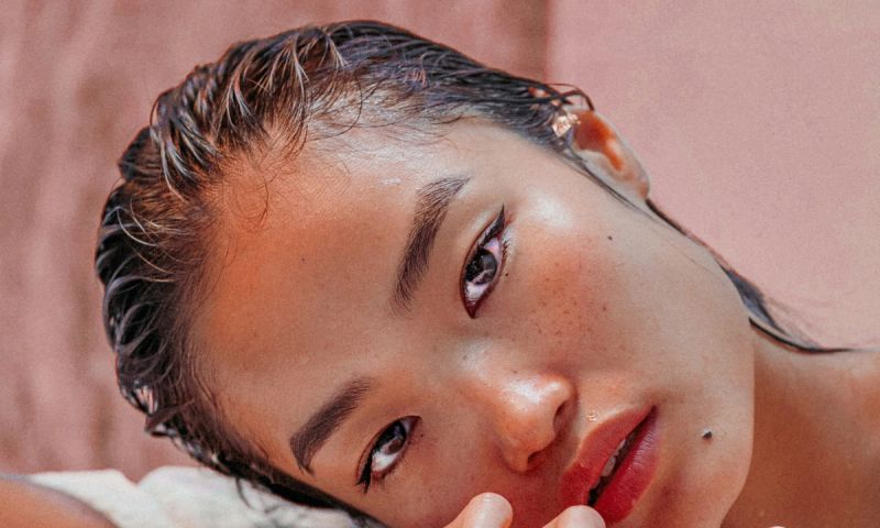 woman with slicked back wet hair