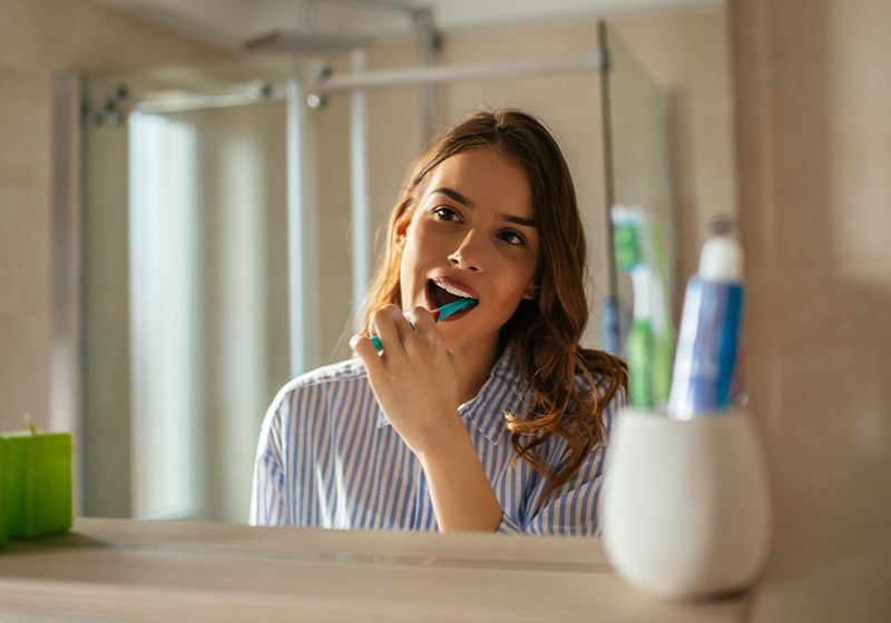 woman brushing teeth