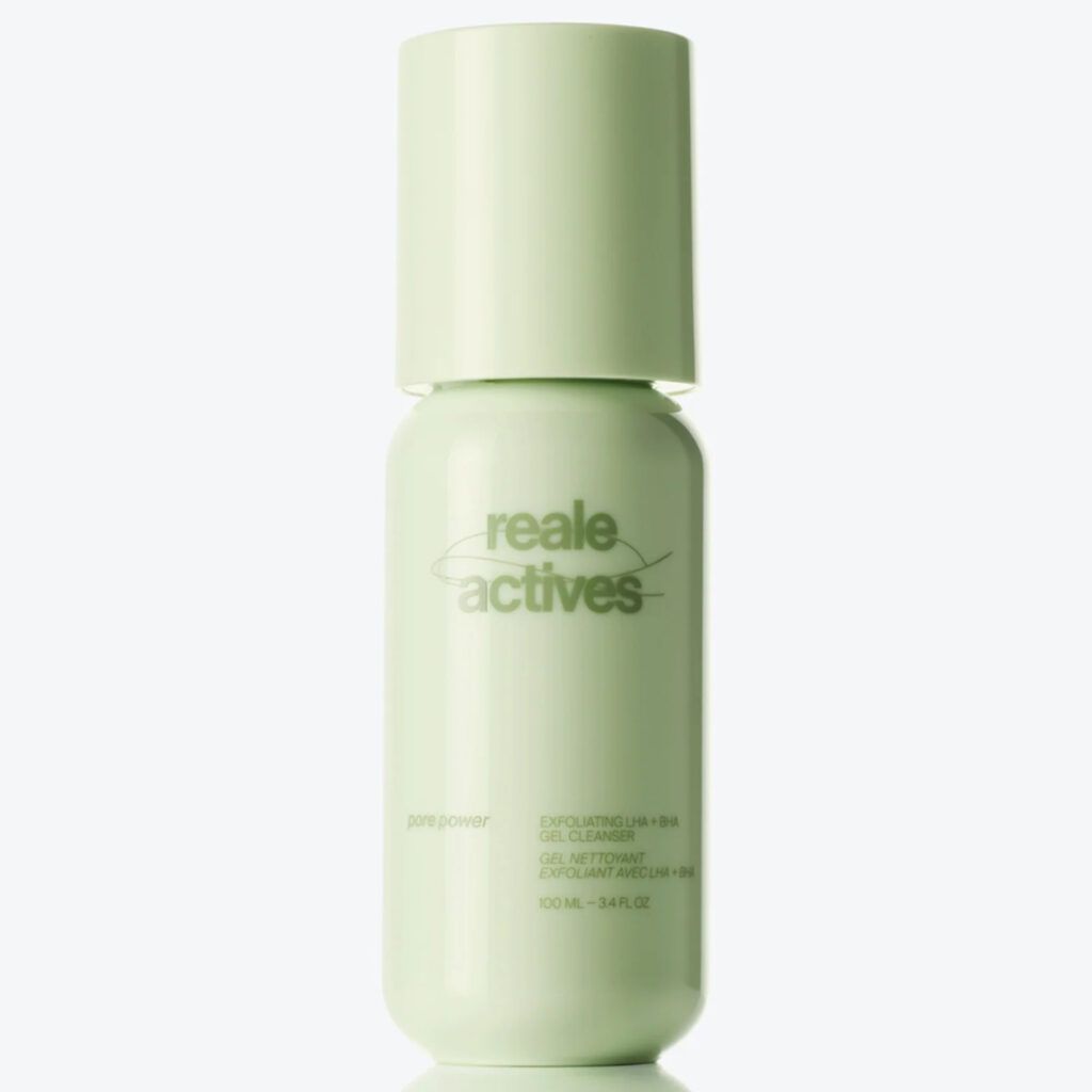 Reale Actives Pore Power Exfoliating LHA + BHA Gel Cleanser in a pale green bottle with a rounded cap and minimalist branding, reflected on a glossy surface against a clean white background.