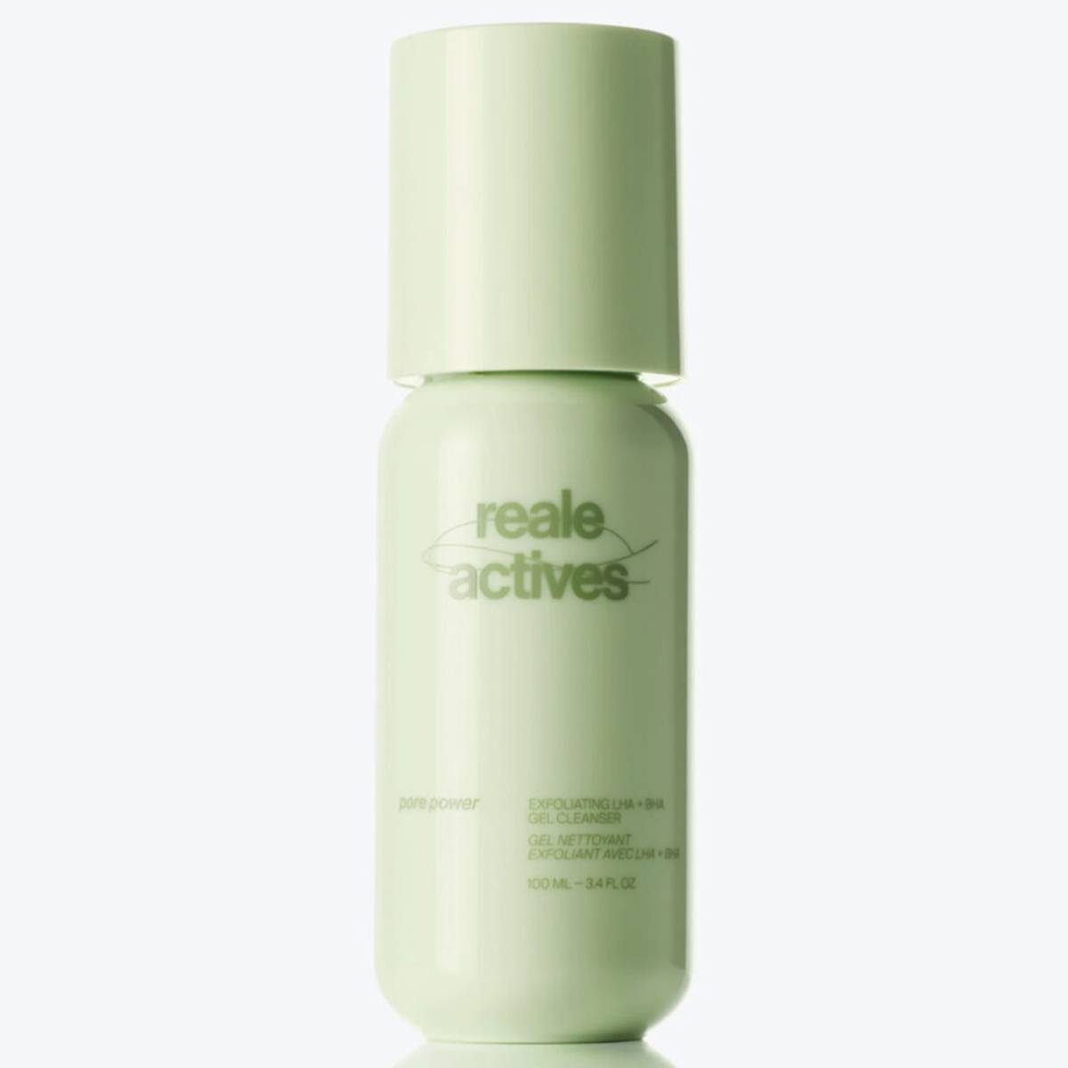 Reale Actives Pore Power Exfoliating LHA + BHA Gel Cleanser in a pale green bottle with a rounded cap and minimalist branding, reflected on a glossy surface against a clean white background.