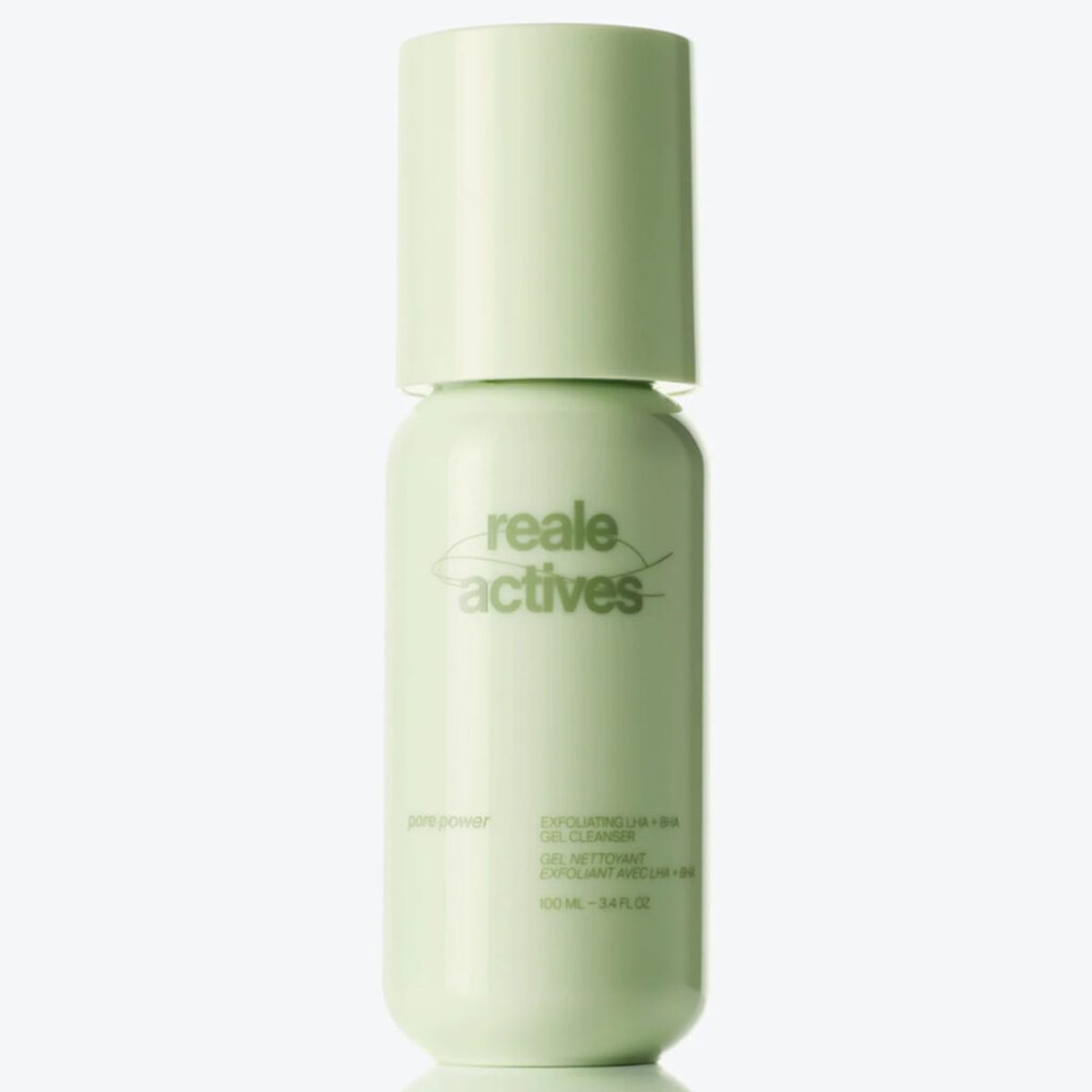 Reale Actives Pore Power Exfoliating LHA + BHA Gel Cleanser in a pale green bottle with a rounded cap and minimalist branding, reflected on a glossy surface against a clean white background.