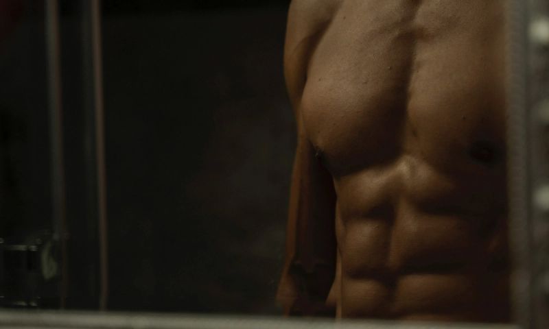 zoomed in photo of man's chest and abdomen