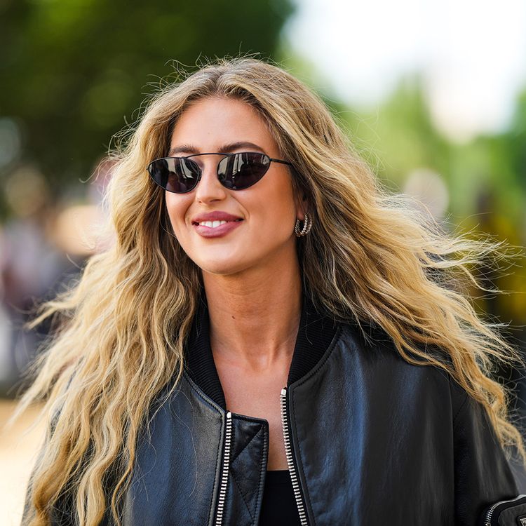 blonde woman walking with long wavy hair