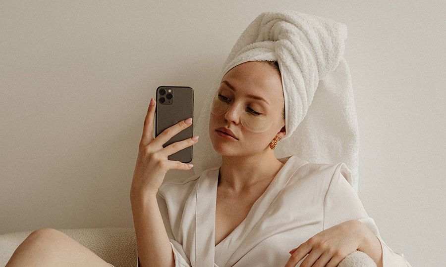 woman taking a selfie wearing eye patches