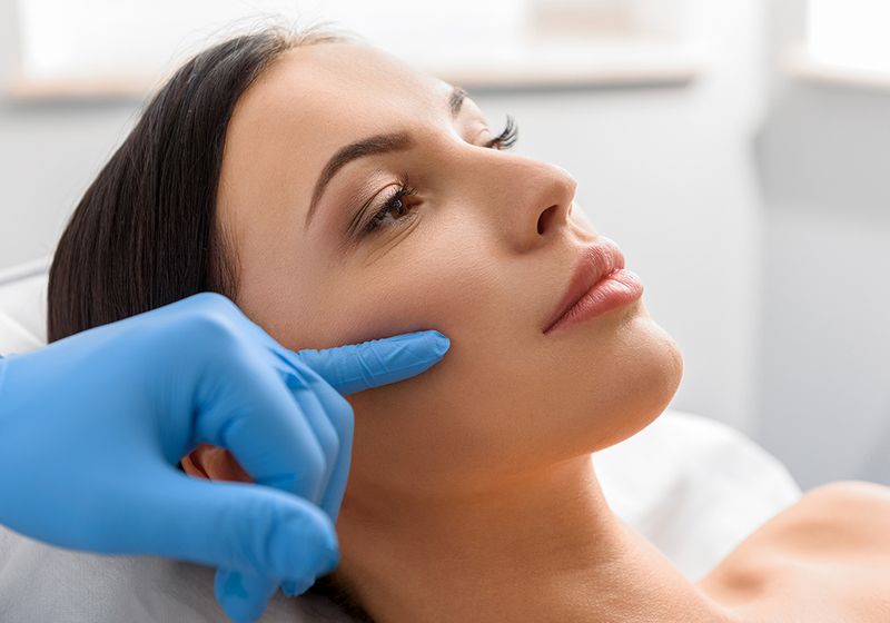 woman getting facial cosmetic treatment consultation