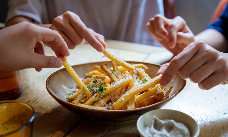 friends-sharing a bowl of french fries