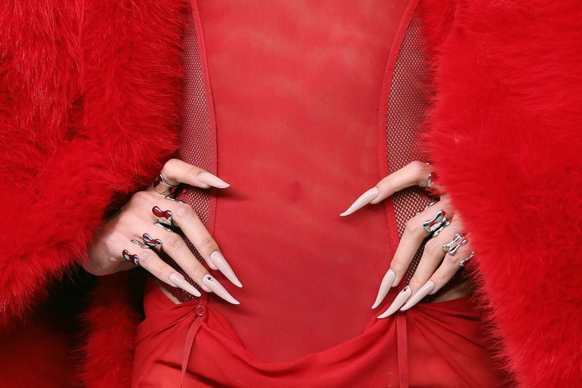 Lisa in a red lace gown with nude talon-shaped nails at the 2026 MTV VMAs