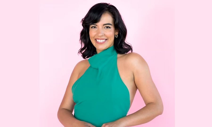 Photo of Danielle Olivera in front of a pink background copy