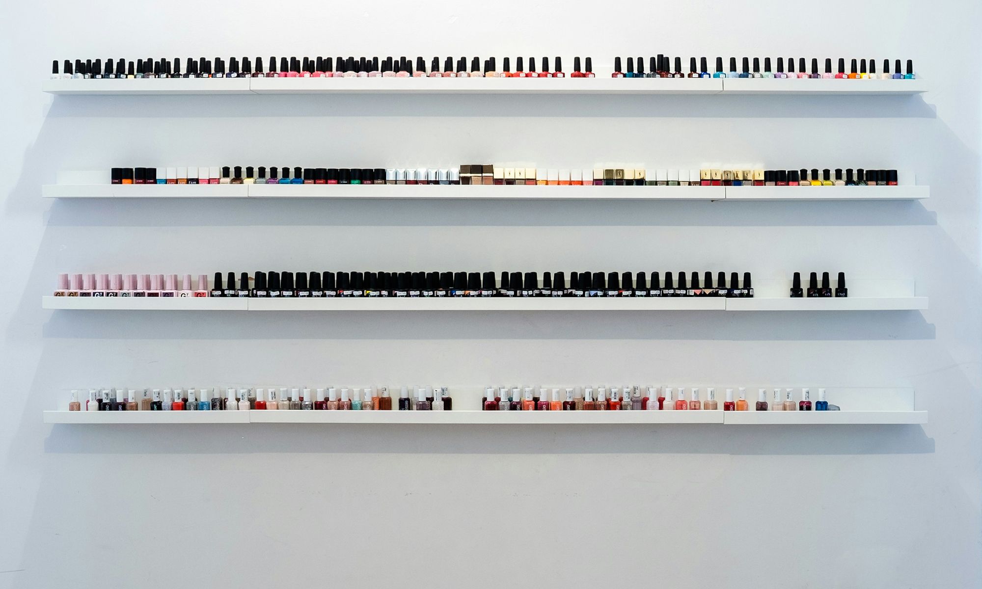 shelves of nail polish bottles in a salon