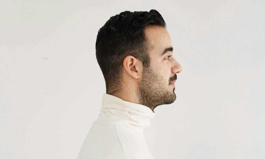 side profile of man in a white turtleneck