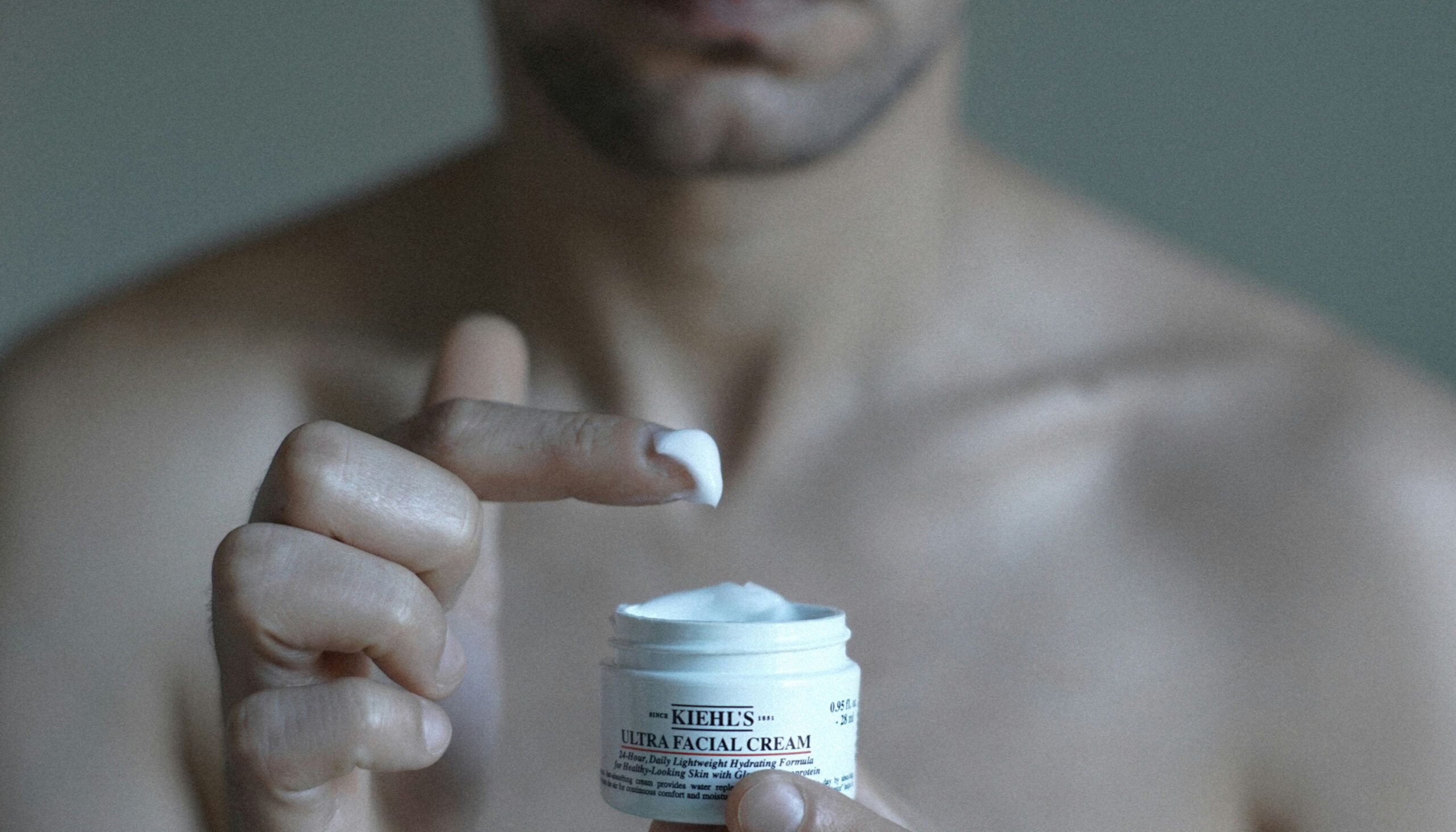 Man holding Kiehl's skin care