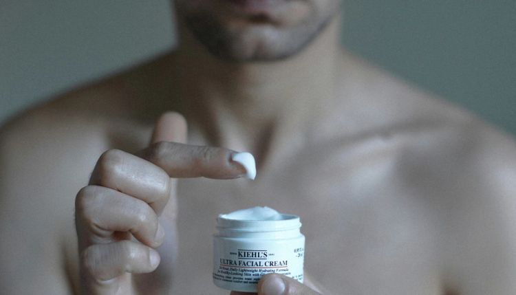 Man holding Kiehl's skin care