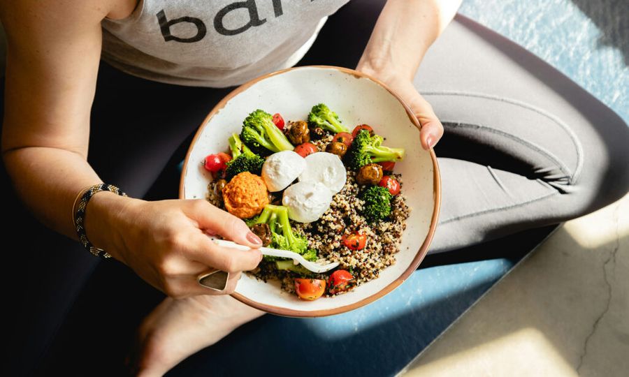 bowl of healthy food in woman's lap