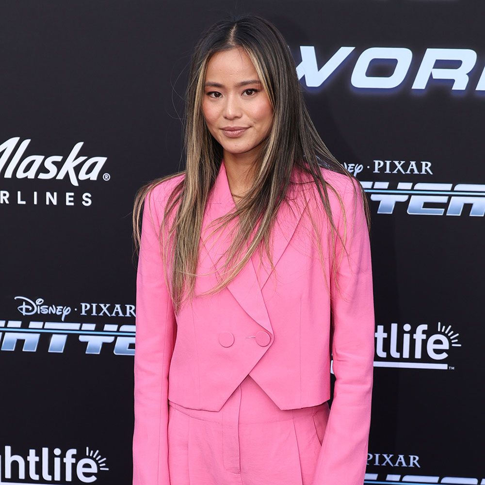 Jamie Chung wearing a bright pink blazer and pants set