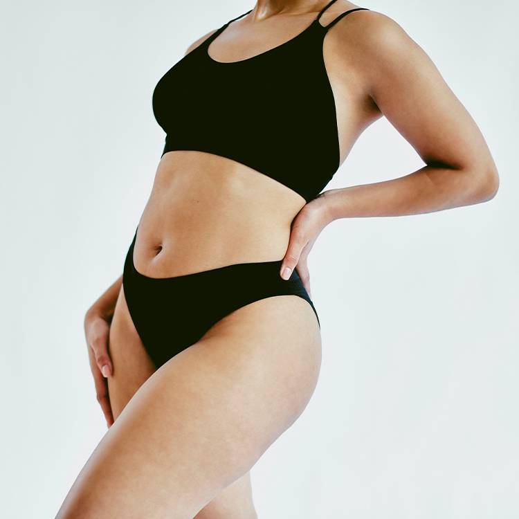 woman's body in black bralette and underwear