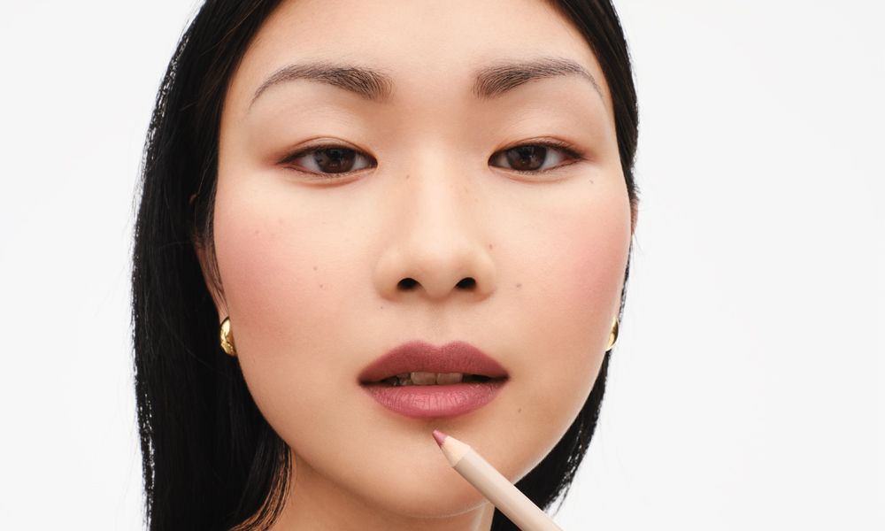 woman applying lip liner