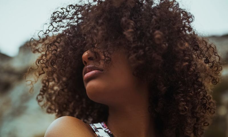 woman with curly hair outdoors