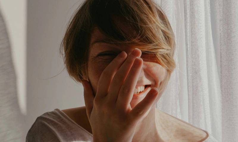 woman with short hair laughing