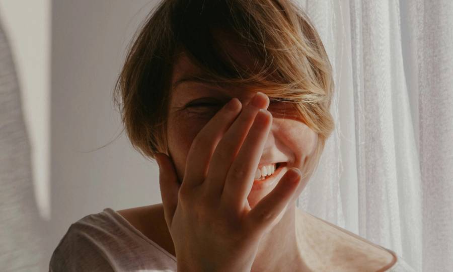 woman with short hair laughing